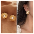 Detailed view of vintage gold spiral pearl earrings on silk and shown on a model - 16# Vintage Ripple Pearl