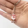 Close-up of a mini Santa Claus keychain held in hand showing soft PVC detail - Santa Claus Style A