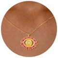 Bohemian gold necklace with sun eye pendant and pink enamel inlay on skin background - Evil Eye Necklace 2