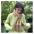 Soft khaki plaid scarf with fringe and OVERSEAS embroidery shown on a model - Heart Plaid Khaki
