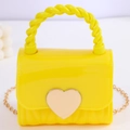 Mini yellow jelly handbag for women featuring gold heart buckle and twisted handle design - Yellow