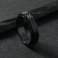 Macro detail of black spinner ring showing textured diamond pattern and rotating band - Black