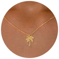 Elegant gold palm tree necklace with sparkling zircon stone on a female neck - Palm Tree Pendant Necklace
