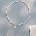 Elegant freshwater pearl bracelet with golden heart shell pendant and T-bar clasp detail - Heart OT Buckle Pearl Necklace