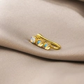 Close-up of golden U-shaped non-piercing nose clip with three iridescent rhinestones - Three-Color Zircon (E3616-1)