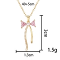 Elegant gold bow necklace with pink zircon and white pearl detailing on a white background - Pearl Bowknot