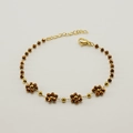 Gold chain bracelet featuring five brown faceted crystal flowers and golden beads - Bronze (Bracelet)