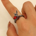 Macro detail of gothic eagle feather ring with rectangular red gemstone inlay - Gun Black Eagle Style (7523)