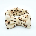 Leopard print coral fleece headband with oversized bow for skincare routines - Almond Leopard