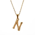 Detail of gold letter N pendant with unique bamboo texture on polished stainless steel - Letter N