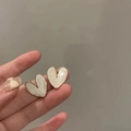 Detail shot of heart-shaped pearl earrings with gold metal edges and elegant finish - 12# Silver Earring Post - Cream White Gold Edge Heart