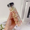 Bunte elastische Haargummis für Mädchen in einem klaren Glaszylinder in der Hand - Helle Bohnen (300 Stück Dose)