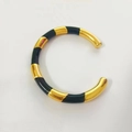 Detail of 18k gold plated open cuff bracelet with black enamel checkerboard pattern - Black Enamel