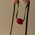 Detail of a handmade red satin rose pendant with elegant black ribbon choker ties - Red