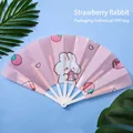 Pink cartoon rabbit folding fan in strawberry pattern with white plastic frame - Strawberry Rabbit