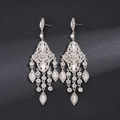 Macro detail of rhinestone chandelier earrings with sparkling gemstone tassels and silver frame - Rhombus Style / Silver