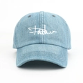 Detailed view of light blue denim baseball cap with white embroidery and stitching - Adjustable / Light Blue