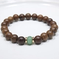 Macro detail of natural wooden beads bracelet with green gemstone and gold metal spacers - 20# (Wood Beads With Green Stone)