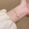 Elegant gold bracelet featuring a round cat-eye gemstone and subtle rhinestone accents - Gold Cat's Eye Rhinestone (MY32057)