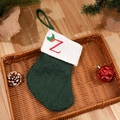Green knitted Christmas stocking with white cuff and red embroidered letter Z detail - Letter Z