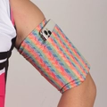Elastic sports armband with multi-color V-shaped pattern holding a silver smartphone - Rainbow