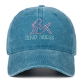 Close-up of pink female silhouette embroidery and SEND NUDES text on washed blue denim cap - Lake Blue