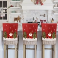 Three red Christmas chair covers with 3D Santa and tree embroidery on kitchen stools - Santa Claus