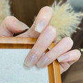 Macro detail of nude cat-eye press-on nails with shimmering finish on long coffin shape - By2376 Cat's Eyes Proud / Glue Type