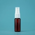 Amber glass spray bottle with white pump head for perfume on blue-green background - 20ml / Amber Bottle White Spray