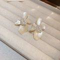 Elegant cream white flower stud earrings with pearl centers on a velvet display tray - Off-white Resin Pearl Flower Earrings (43#)