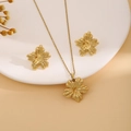 Golden flower-shaped necklace and earring set with leaf texture on beige display - Textured Flower Style (E6210-5)