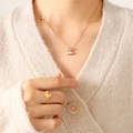 Rose gold butterfly jewelry set featuring a sparkling necklace and adjustable ring on a model - Butterfly Necklace / Rose Gold