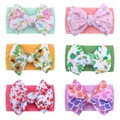 Set of six colorful nylon baby headbands with floral and unicorn prints on white background - 6-Piece Set