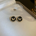 Detailed macro view of French vintage earrings with golden butterfly relief on black disks - 10# Silver Pin - Black Butterfly Circle