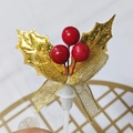 Christmas cake topper featuring gold leaves, red berries, and a mesh bow decoration - Three Berries Gold Leaves