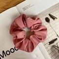 Pink PU leather scrunchie with lychee texture placed on a magazine background - Pink