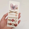 Candy colored hair clip set featuring purple bow, pearls, and heart shapes held in hand - Butterfly Love (6 Piece Set)