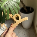 Detail of cream apricot hair claw clip with golden spring mechanism and matte finish - Jelly Apricot