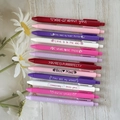 12-pack Valentine-themed retractable gel pens with puns on a wooden surface - 12Pcs Valentine's Day Puns Series