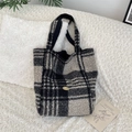 Close-up of golden Sozakka logo on fluffy checkerboard wool tote bag texture - Black Big Check