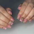 Macro detail of pink french nails with gold bow decor and leopard pattern accents - Bz1604 Crimson Face / Glue Type