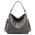 Detail view of dark grey pebble leather handbag with V-shaped zipper and gold hardware - Light Gray