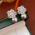 Macro shot of elegant snowflake pearl earrings with zircon stones on a green jewelry box - 59# Silver Grey Large Pearl Snowflake Style (HE30401)