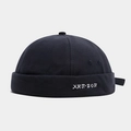 Detailed close-up of navy blue hip-hop docker cap featuring white letter embroidery - Adjustable / Dark Gray