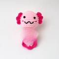 Handmade pink knitted axolotl doll holding a white motivational card for decor - Mermaid Axolotl Pink Body Rose Red Gill A Card