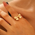 Golden stainless steel bow ring for women shown on index finger with polished finish - Gold Bow Ring (5043)