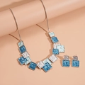 Detail showing blue geometric square enamel pendant necklace and matching stud earrings set - Blue 2-Piece Set