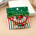 Detailed view of handmade woven Christmas bracelets with festive charms on display cards - S326 2Pcs Braided Rope Bracelet Set With Santa/Snowman/Deer Charms