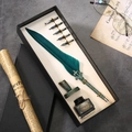 Vintage green feather quill pen gift set with ink and nibs on a classic desk - Dark Green