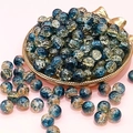 Macro shot of 10mm blue crackle glass beads in a gold tray for DIY jewelry making - Dunhuang Style